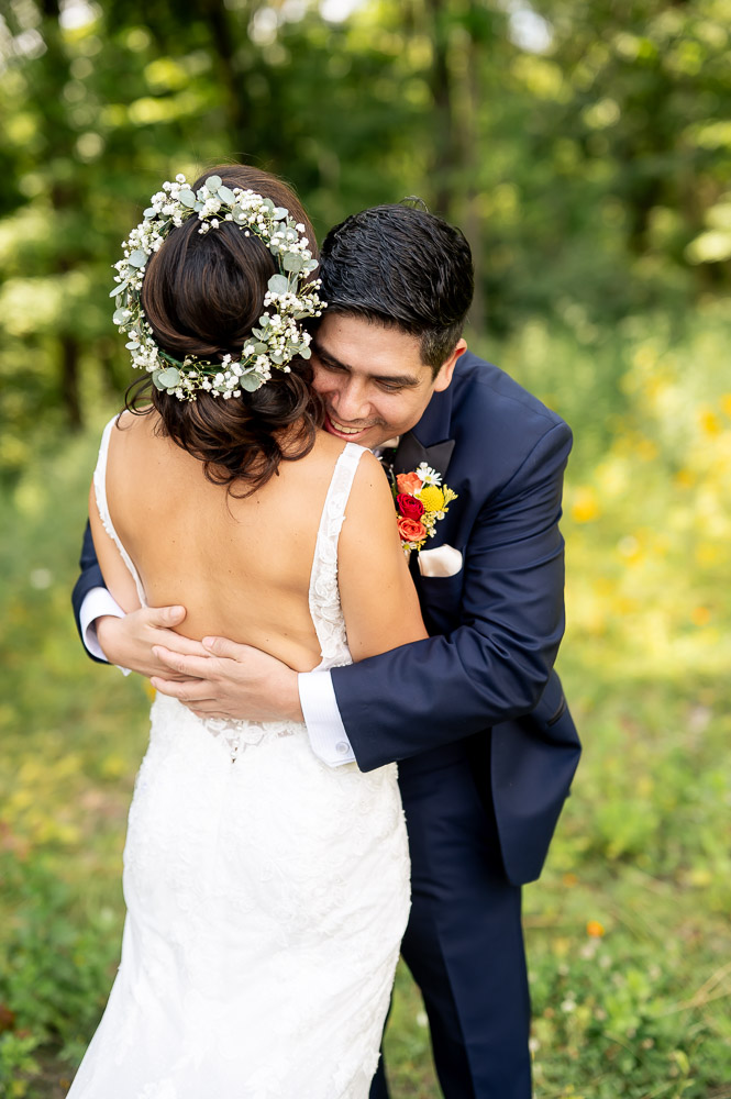 groom embracing bride during first look at rock island lake club