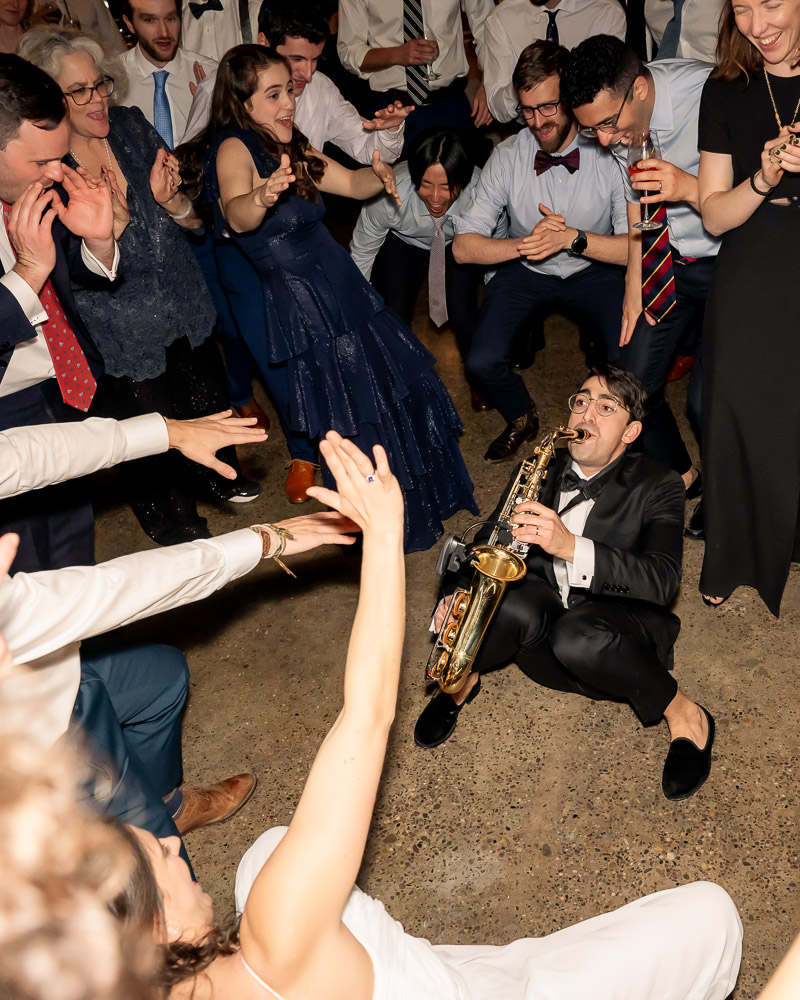 groom plays the saxaphone during wedding reception at Lilah in Fishtown