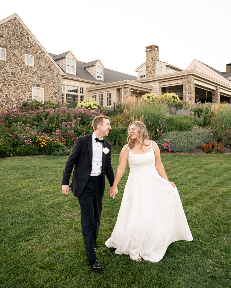 Bride and groom walk together during their wedding at French Creek Golf Club